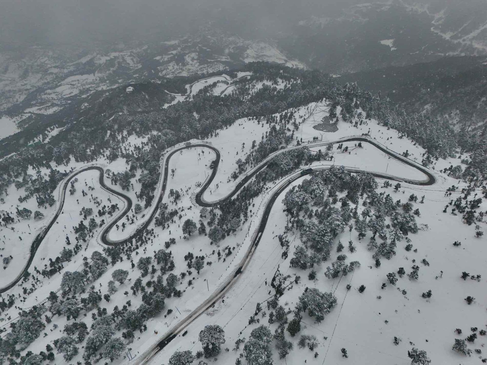 Wild Hill Adventure Aerial view of a winding mountain road covered in snow, Tawang